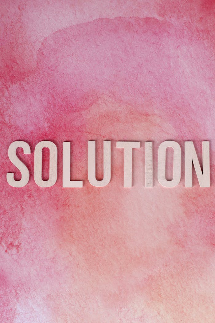 about-img-01 Inspirational 'Solution' text on a vibrant pink watercolor background for motivation and problem-solving concepts.
